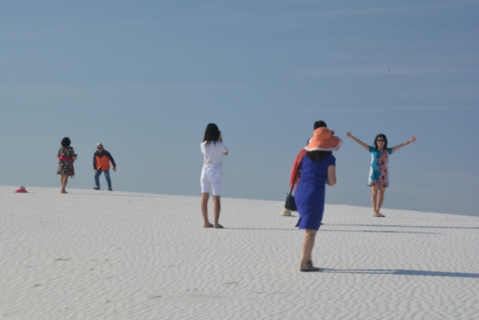 visitors climbing a dune